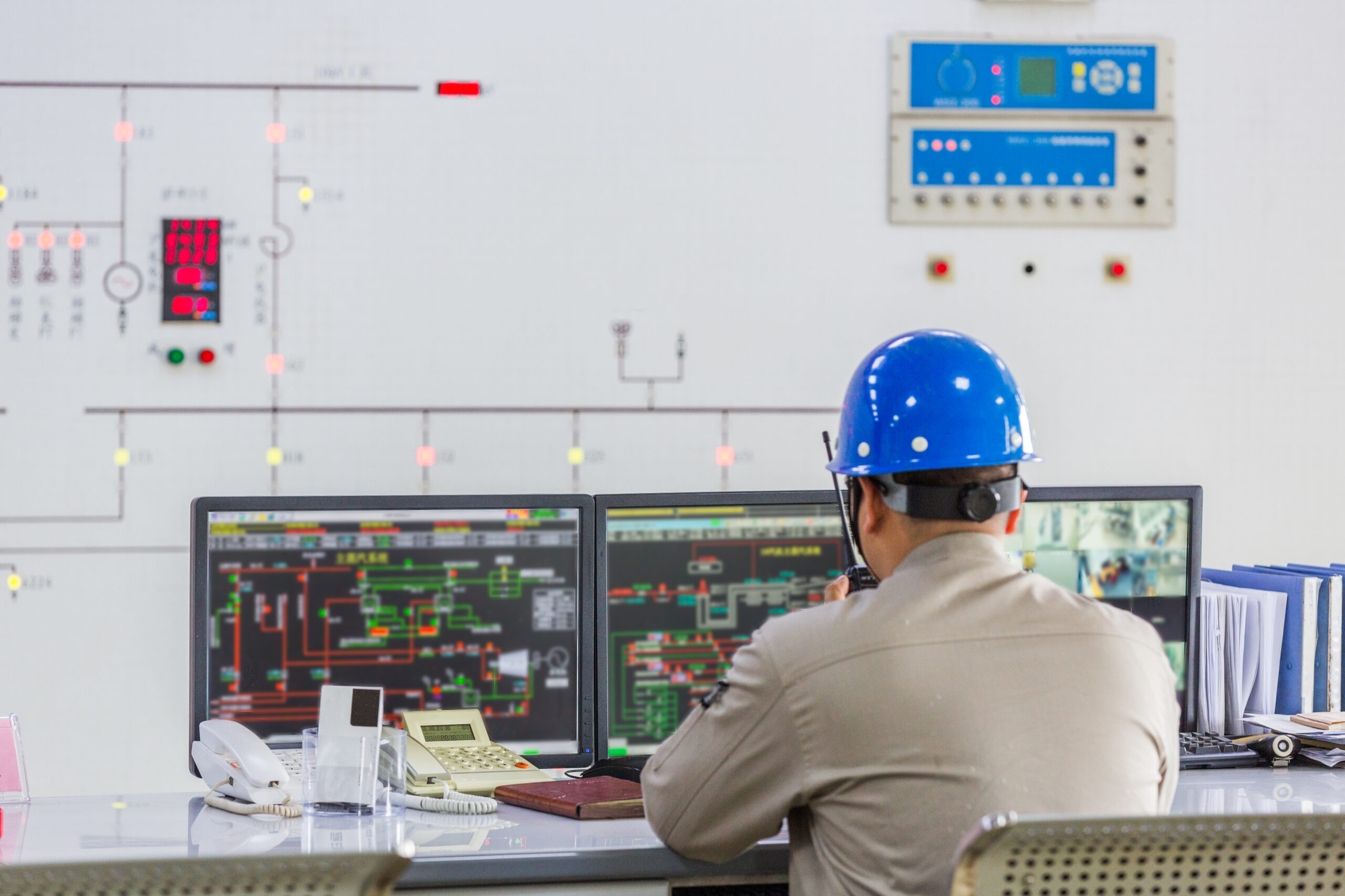 workers in control room of a factory.